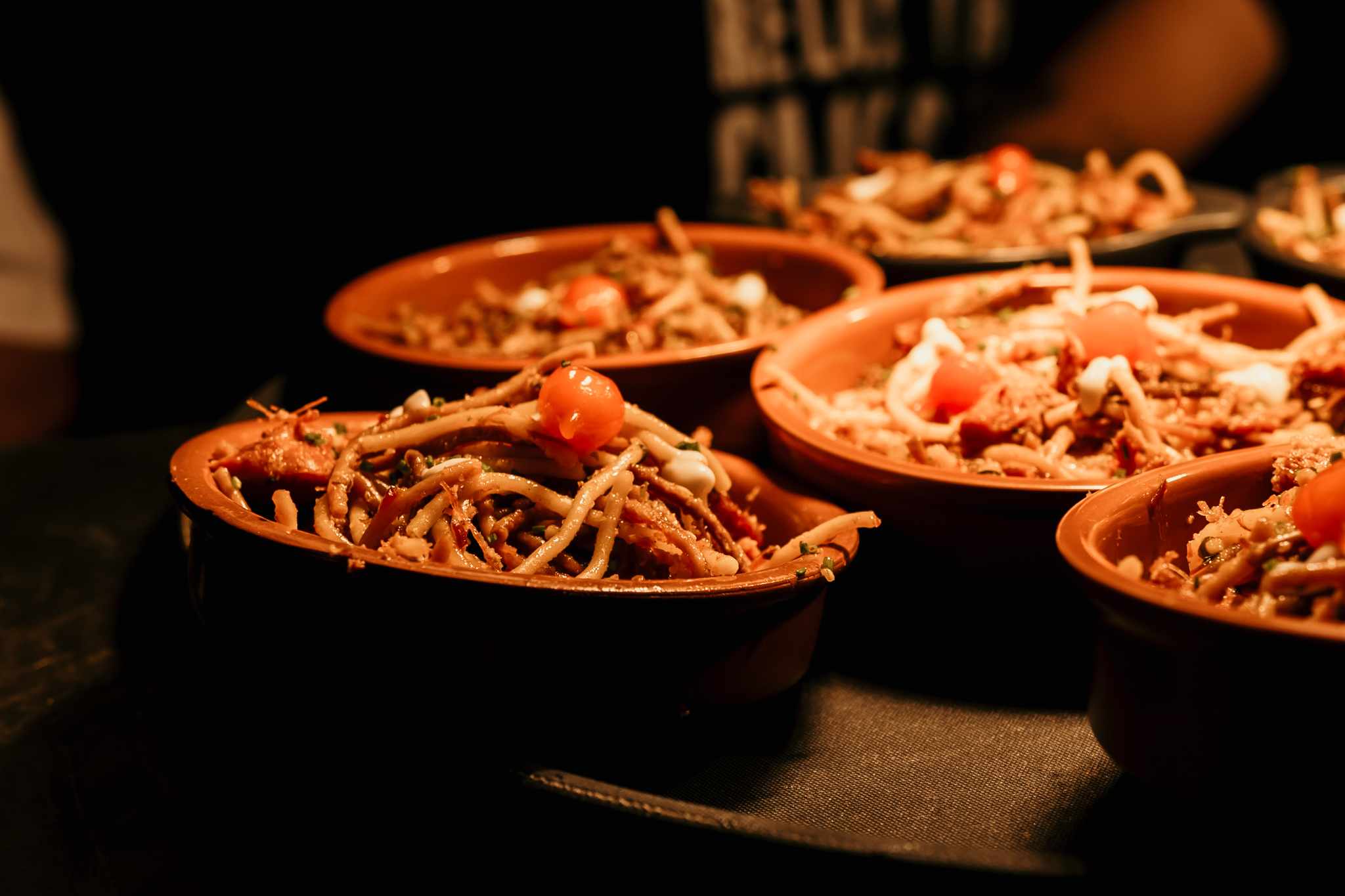 Bowls of a hot, slow-cooked dish being served to guests at a Bossa roadshow.